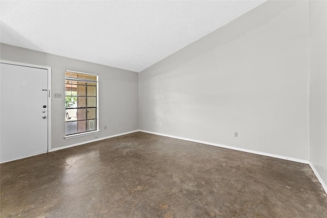 6201 Berkett Cv, Austin, TX 78745 - empty room with finished concrete floors and vaulted ceiling