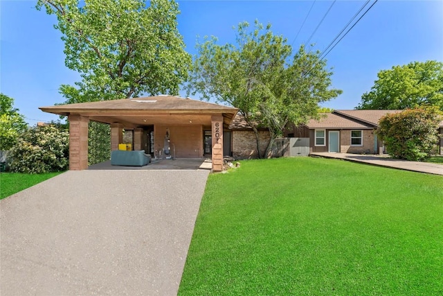 6201 Berkett Cv, Austin, TX 78745 - ranch-style home with driveway, a carport, and a front yard