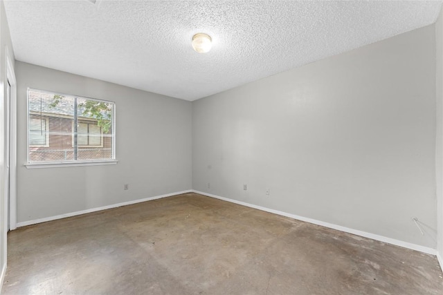 6201 Berkett Cv, Austin, TX 78745 - empty room with unfinished concrete floors and a textured ceiling