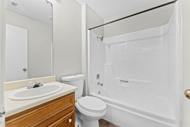 6201 Berkett Cv, Austin, TX 78745 - full bath featuring a textured ceiling, vanity, and shower / tub combination