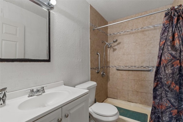 7105 Bethune Ave, Austin, TX 78752 - bathroom featuring a textured wall, vanity, and tiled shower