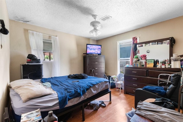 7105 Bethune Ave, Austin, TX 78752 - bedroom featuring wood finished floors and a textured ceiling