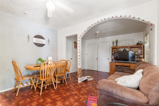 7105 Bethune Ave, Austin, TX 78752 - dining area with ceiling fan, arched walkways, and a textured ceiling