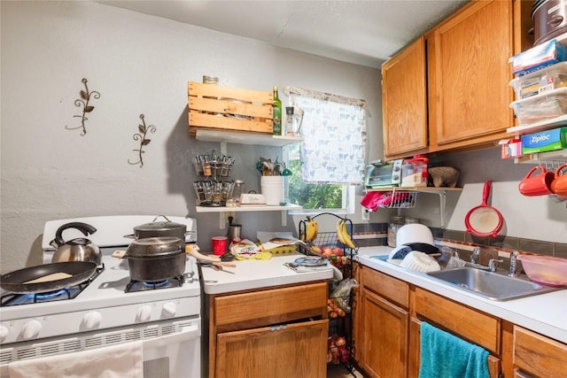 7105 Bethune Ave, Austin, TX 78752 - kitchen with gas range gas stove, light countertops, and brown cabinets