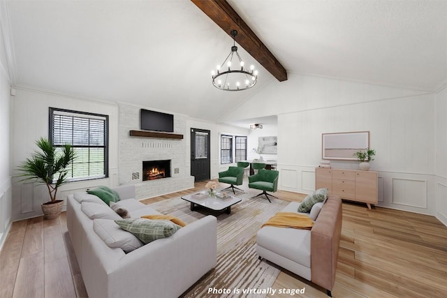 1107 Timmons Dr, Copperas Cove, TX 76522 - living area featuring light wood finished floors, a decorative wall, a large fireplace, and a chandelier