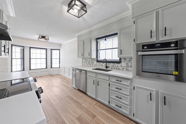 1107 Timmons Dr, Copperas Cove, TX 76522 - kitchen featuring stainless steel appliances, ornamental molding, a textured ceiling, light countertops, and light wood-type flooring