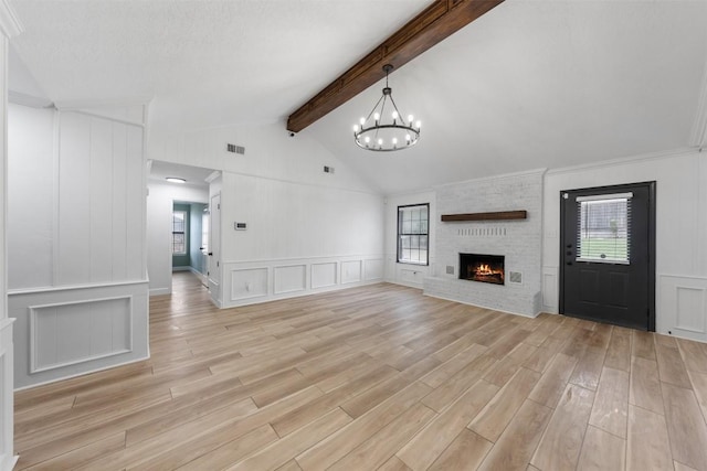 1107 Timmons Dr, Copperas Cove, TX 76522 - unfurnished living room featuring a decorative wall, healthy amount of natural light, a fireplace, and light wood finished floors