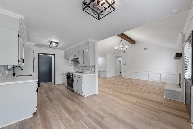 1107 Timmons Dr, Copperas Cove, TX 76522 - kitchen featuring stainless steel range with electric stovetop, a chandelier, light countertops, a decorative wall, and backsplash