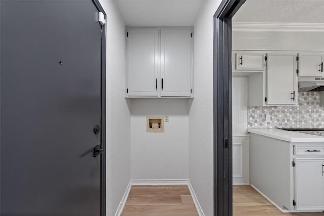 1107 Timmons Dr, Copperas Cove, TX 76522 - laundry room featuring hookup for a washing machine, light wood-type flooring, and cabinet space