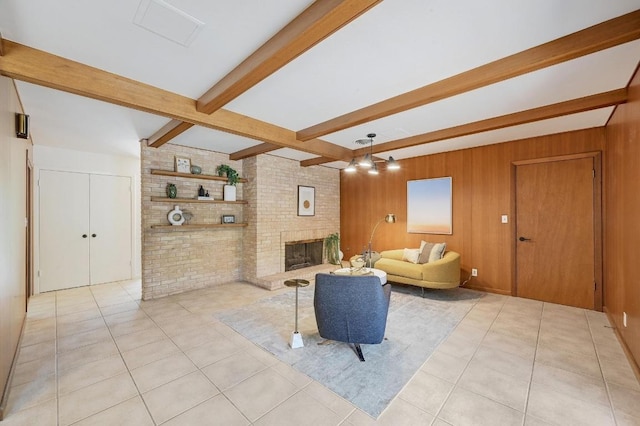 5912 Highland Hills Dr, Austin, TX 78731 - living room with beam ceiling, light tile patterned floors, a fireplace, and brick wall