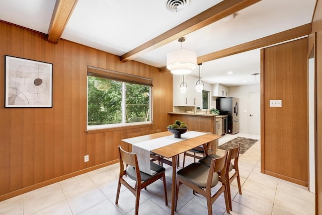 5912 Highland Hills Dr, Austin, TX 78731 - dining area with beamed ceiling, light tile patterned floors, and wood walls
