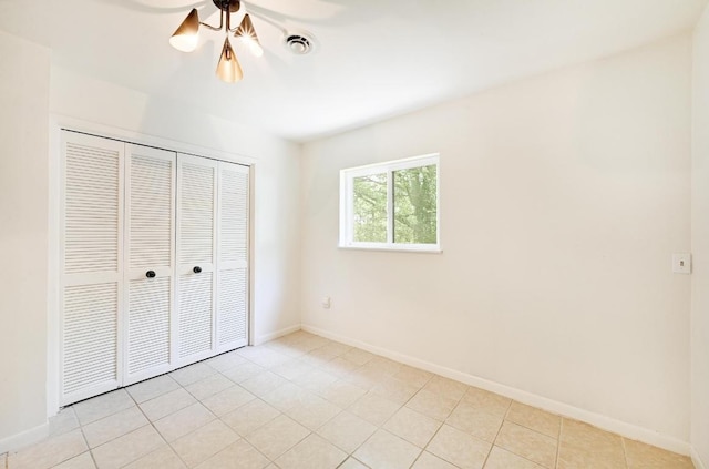 5912 Highland Hills Dr, Austin, TX 78731 - unfurnished bedroom featuring a closet and light tile patterned floors