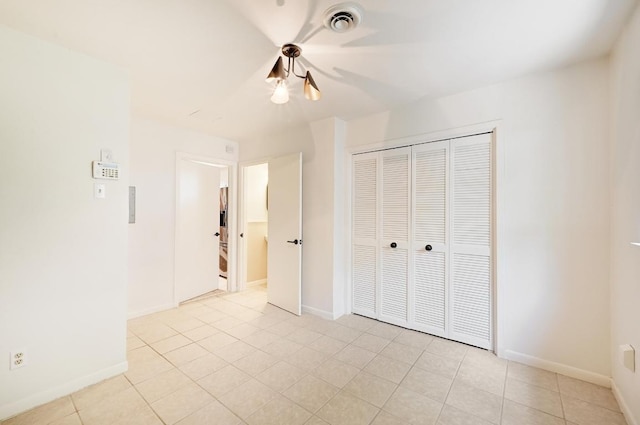 5912 Highland Hills Dr, Austin, TX 78731 - unfurnished bedroom with light tile patterned floors, a closet, and ceiling fan