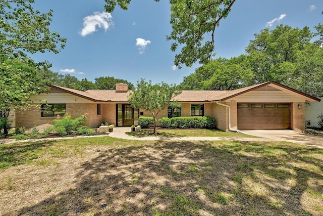 5912 Highland Hills Dr, Austin, TX 78731 - ranch-style house with brick siding, an attached garage, driveway, and a chimney