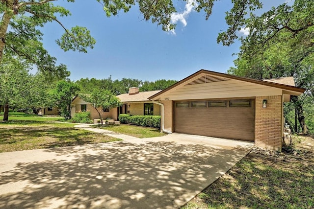 5912 Highland Hills Dr, Austin, TX 78731 - ranch-style home featuring brick siding, driveway, a garage, and a front lawn