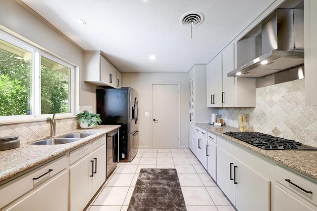 5912 Highland Hills Dr, Austin, TX 78731 - kitchen with wall chimney range hood, black gas stovetop, dishwasher, tasteful backsplash, and stainless steel refrigerator with ice dispenser