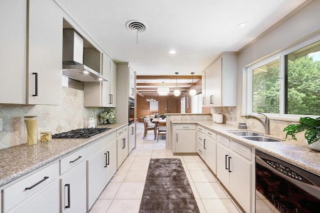 5912 Highland Hills Dr, Austin, TX 78731 - kitchen with black dishwasher, stainless steel gas cooktop, wall chimney range hood, decorative backsplash, and light stone counters