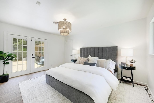 5912 Highland Hills Dr, Austin, TX 78731 - bedroom featuring french doors, access to outside, and wood finished floors