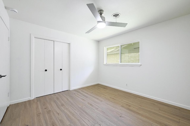 5912 Highland Hills Dr, Austin, TX 78731 - unfurnished bedroom featuring wood finished floors, a closet, and a ceiling fan