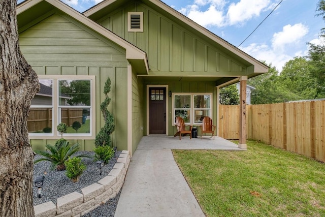 815 Fir Ln, Lockhart, TX 78644 - view of front facade featuring board and batten siding and a patio