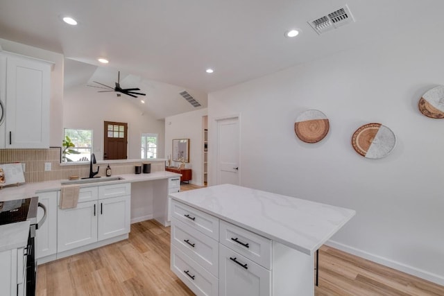 815 Fir Ln, Lockhart, TX 78644 - kitchen featuring light wood-style floors, tasteful backsplash, a peninsula, recessed lighting, and electric range