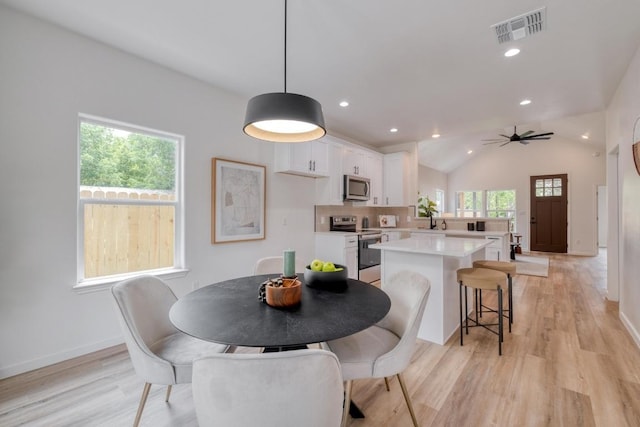 815 Fir Ln, Lockhart, TX 78644 - dining space featuring light wood-type flooring, ceiling fan, vaulted ceiling, and recessed lighting