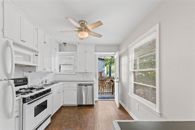 1301 Piedmont Ave, Austin, TX 78757 - kitchen with white appliances, white cabinets, ceiling fan, and backsplash