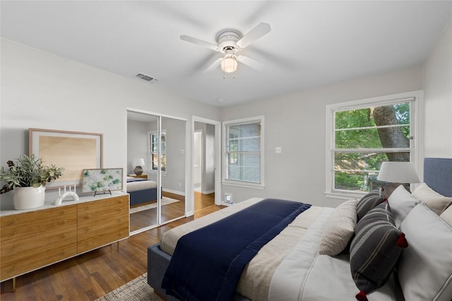 1301 Piedmont Ave, Austin, TX 78757 - bedroom with dark wood-style floors, a closet, and a ceiling fan
