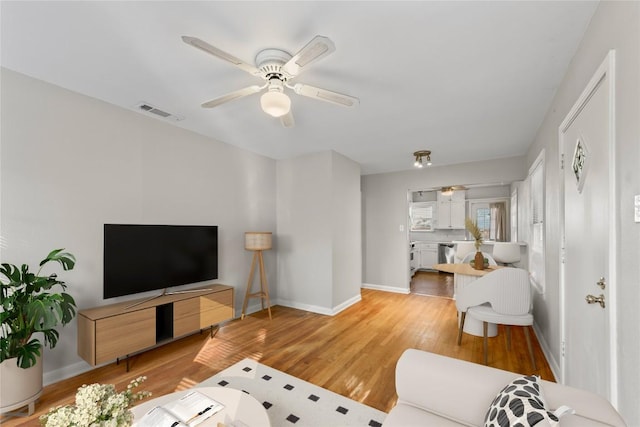 1301 Piedmont Ave, Austin, TX 78757 - living area featuring a ceiling fan and light wood finished floors