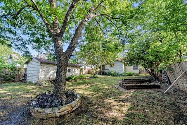 1301 Piedmont Ave, Austin, TX 78757 - fenced backyard with an outdoor structure and a garden