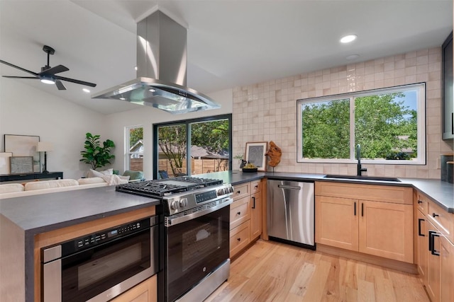 6209 Waycross Dr, Austin, TX 78745 - kitchen with appliances with stainless steel finishes, island range hood, light brown cabinets, backsplash, and recessed lighting