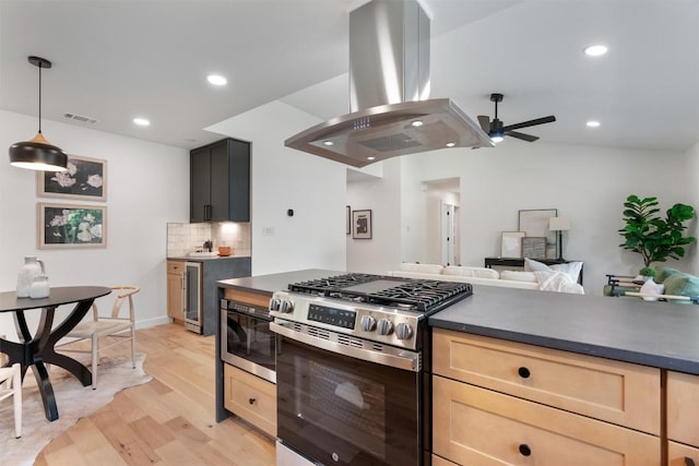 6209 Waycross Dr, Austin, TX 78745 - kitchen featuring island exhaust hood, gas range, dark countertops, ceiling fan, and light brown cabinets