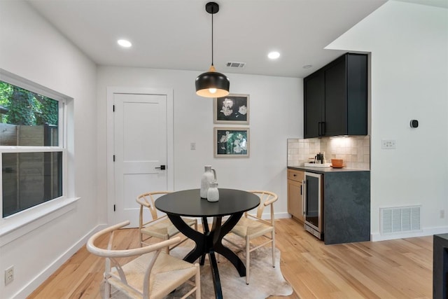 6209 Waycross Dr, Austin, TX 78745 - dining space with light wood-style flooring, wine cooler, bar area, and recessed lighting