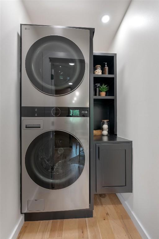 6209 Waycross Dr, Austin, TX 78745 - washroom featuring stacked washing machine and dryer, light wood finished floors, and recessed lighting
