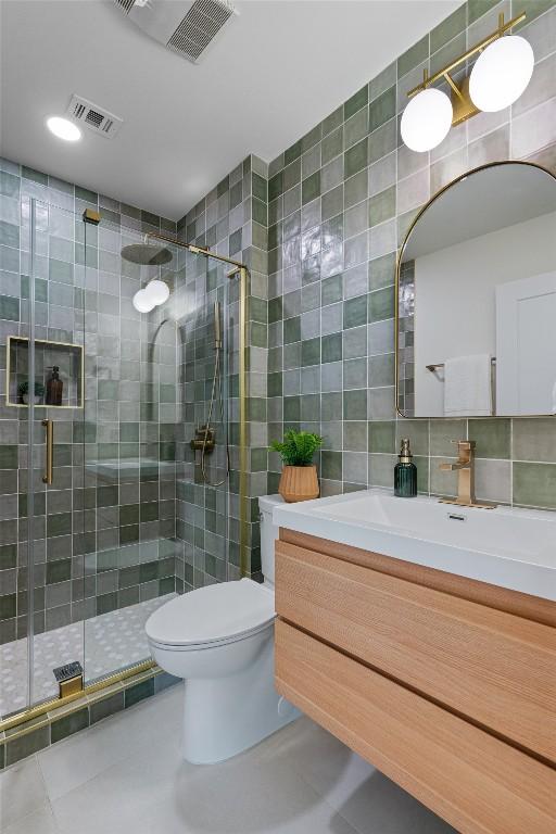 6209 Waycross Dr, Austin, TX 78745 - full bathroom featuring tile walls, a stall shower, vanity, backsplash, and tile patterned floors