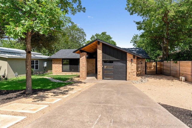 6209 Waycross Dr, Austin, TX 78745 - modern home with a garage, concrete driveway, brick siding, and roof with shingles