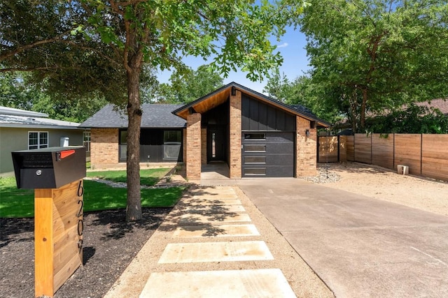 6209 Waycross Dr, Austin, TX 78745 - contemporary house featuring brick siding, concrete driveway, an attached garage, and board and batten siding