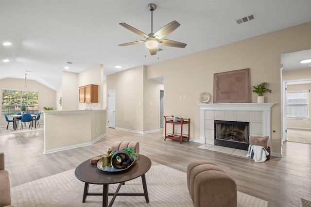 301 River Crossing Trl, Round Rock, TX 78665 - living area with light wood-style floors, ceiling fan, vaulted ceiling, a fireplace, and recessed lighting