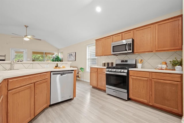 301 River Crossing Trl, Round Rock, TX 78665 - kitchen featuring stainless steel appliances, tasteful backsplash, ceiling fan, light wood-style flooring, and light countertops