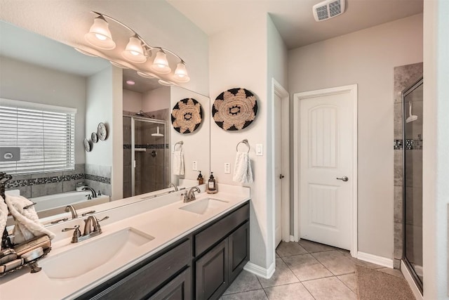 18920 Still Pond Rd, Pflugerville, TX 78660 - bathroom featuring a shower stall, a bath, double vanity, and tile patterned flooring