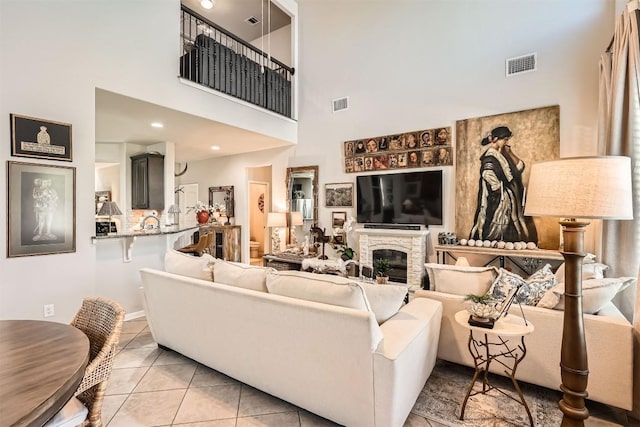 18920 Still Pond Rd, Pflugerville, TX 78660 - living area featuring a towering ceiling, light tile patterned floors, and a glass covered fireplace
