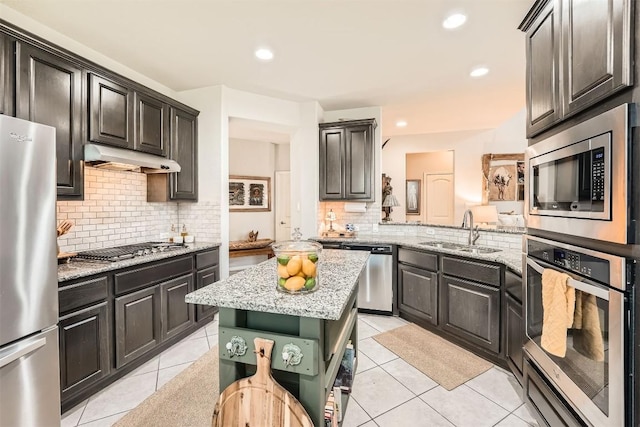 18920 Still Pond Rd, Pflugerville, TX 78660 - kitchen featuring stainless steel appliances, light tile patterned floors, backsplash, light stone countertops, and recessed lighting