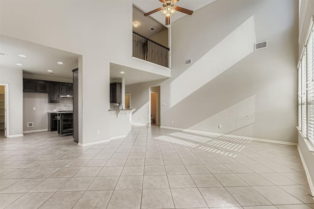 18920 Still Pond Rd, Pflugerville, TX 78660 - unfurnished living room featuring a ceiling fan, light tile patterned flooring, a towering ceiling, and recessed lighting
