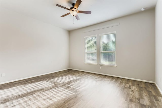 18920 Still Pond Rd, Pflugerville, TX 78660 - spare room with wood finished floors, a ceiling fan, and a smoke detector