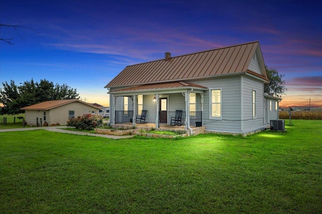 17205 County Line Rd, Elgin, TX 78621 - view of front facade with a porch, a standing seam roof, a front yard, and a metal roof