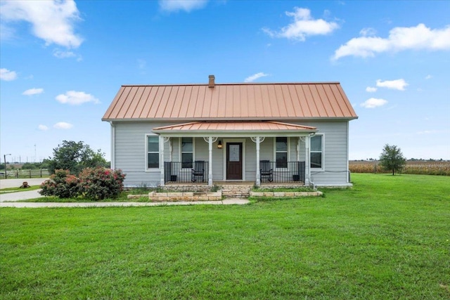 17205 County Line Rd, Elgin, TX 78621 - view of front of property featuring covered porch, a standing seam roof, a front lawn, a metal roof, and a chimney
