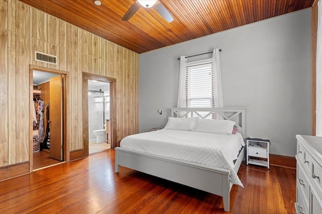 17205 County Line Rd, Elgin, TX 78621 - bedroom with wooden ceiling, dark wood-style floors, ensuite bathroom, a ceiling fan, and a spacious closet