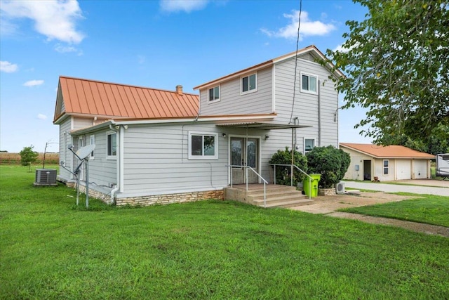 17205 County Line Rd, Elgin, TX 78621 - rear view of house with a lawn, a metal roof, french doors, and a standing seam roof