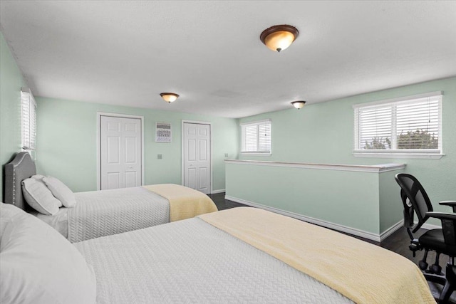 17205 County Line Rd, Elgin, TX 78621 - bedroom featuring dark wood-style flooring and multiple closets