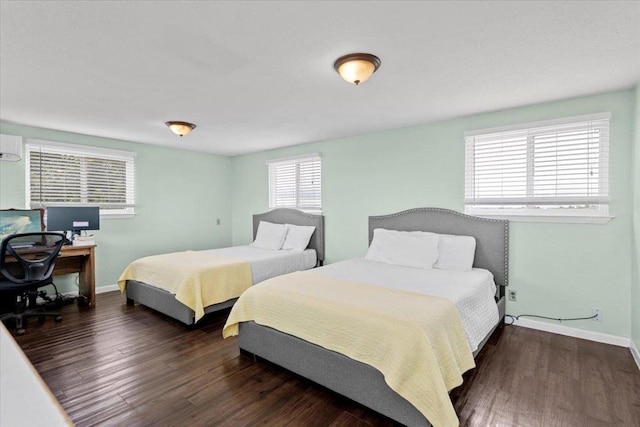 17205 County Line Rd, Elgin, TX 78621 - bedroom with wood finished floors, a desk, and a wall unit AC